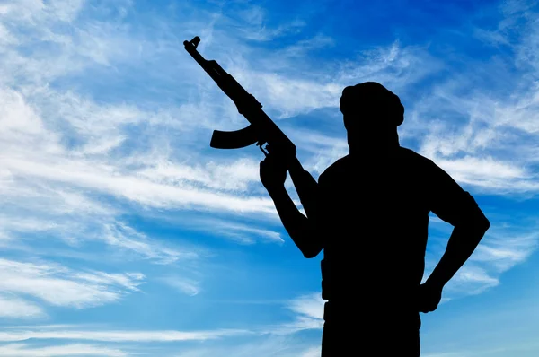 Silhouette of a terrorist with a weapon — Stock Photo, Image