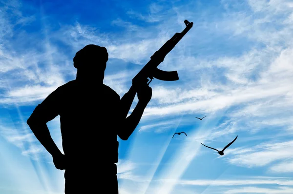 Silhouette of a terrorist with a weapon — Stock Photo, Image