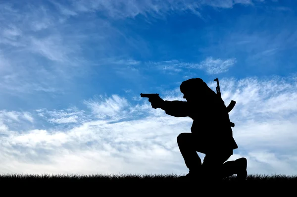 Silhouette of a terrorist with a gun — Stock Photo, Image