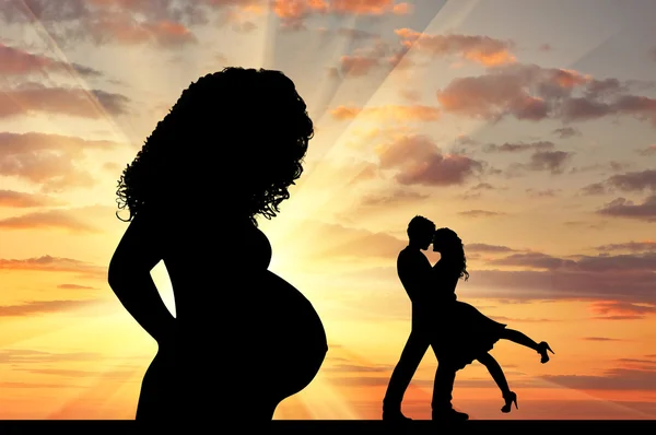 Silhouette a pregnant woman and  loving couple — Stock Photo, Image