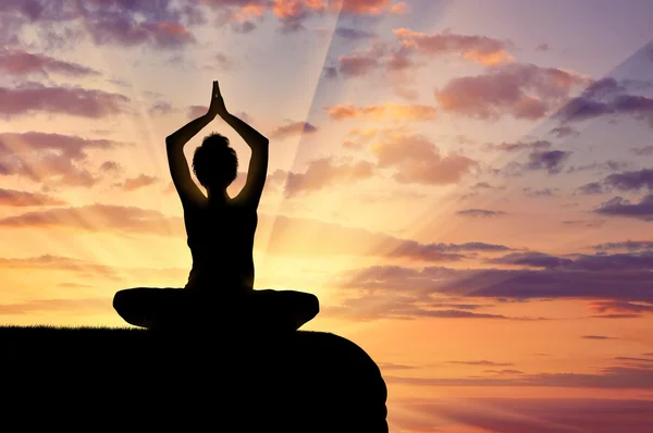 Silhouette of a girl practicing yoga — Stock Photo, Image