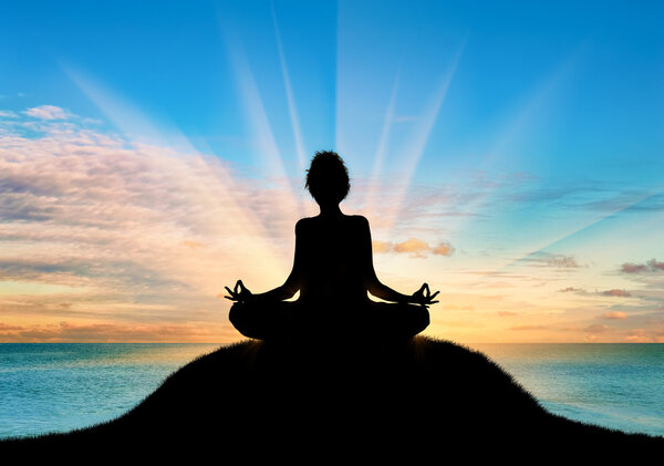Silhouette of a girl practicing yoga 