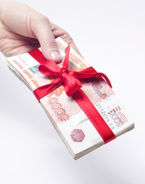 Stack of money tied with a ribbon in the hands