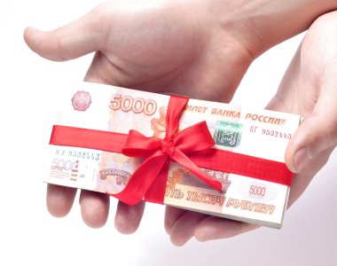 Stack of money tied with a ribbon in the hands