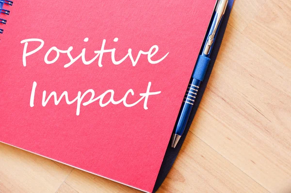 Positive impact write on notebook — Stock Photo, Image