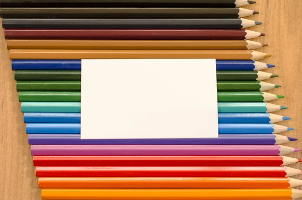 Blank white paper and colored pencil on wooden background — Stock Photo, Image