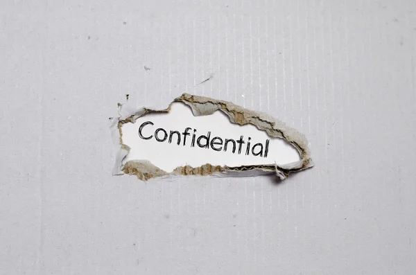 The word confidential appearing behind torn paper. — Stock Photo, Image