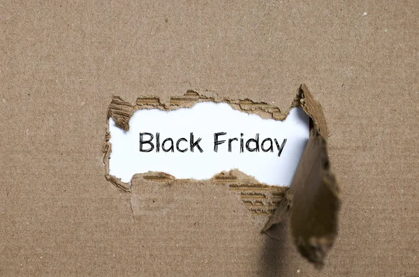 The word black friday appearing behind torn paper — Stock Photo, Image