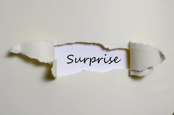 The word surprise appearing behind torn paper — Stock Photo, Image