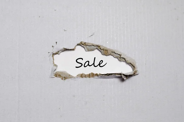 The word sale appearing behind torn paper — Stock Photo, Image