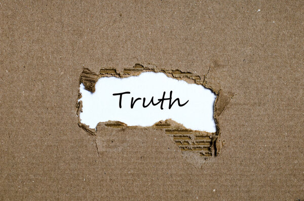 The word truth appearing behind torn paper