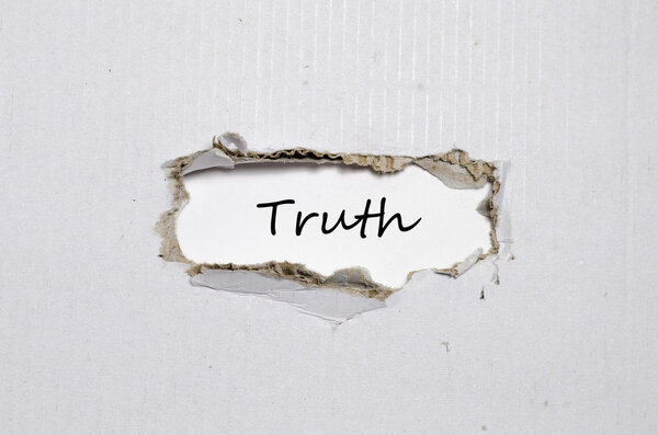 The word truth appearing behind torn paper