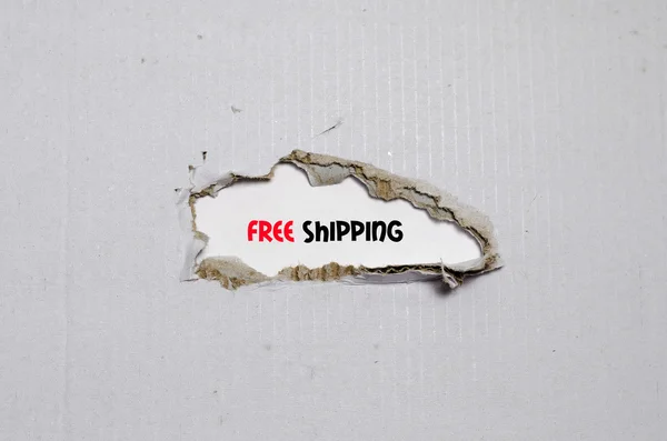 The word free shipping appearing behind torn paper — Stock Photo, Image