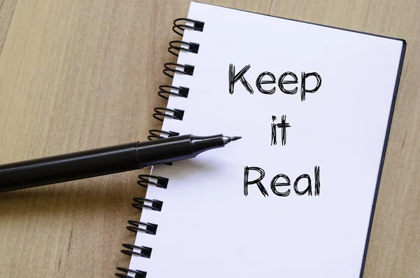 Keep it real write on notebook — Stock Photo, Image
