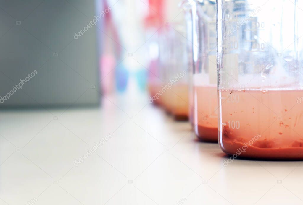 Waste water sample in beakers coagulation and flocculation method with Ferric chlorine and using Jar test for forming precipitation and reduced turbidity calibration range. Use for science background.