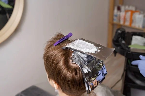 hair dyeing process with foil. beauty saloon