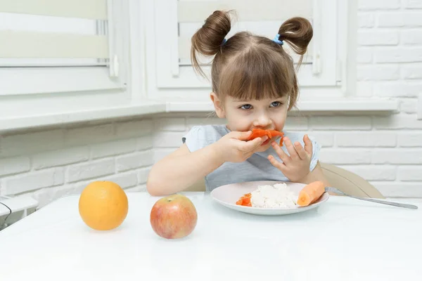 caucasian child girl eating rice with vegetables. The concept of choosing a healthy diet.