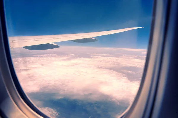 Beautiful aerial view seen through window of flying aeroplane. Aircraft illuminator window view