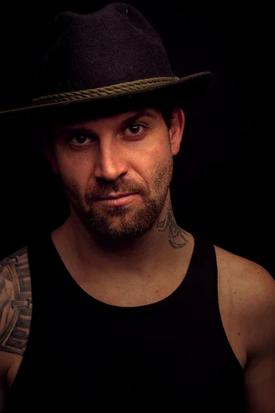 Low key portrait of gangster with hat in the darkness — Stock Photo, Image