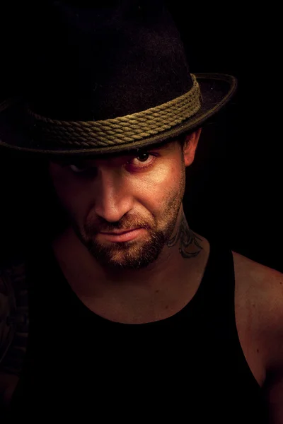 Low key portrait of gangster with hat in the darkness — Stock Photo, Image