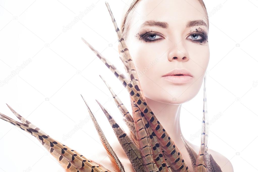 beautiful woman model with feathers