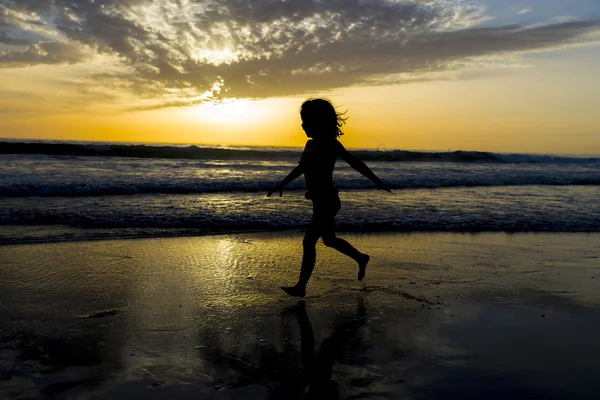 Little girl bathing on the beach at dusk — Stock Photo, Image