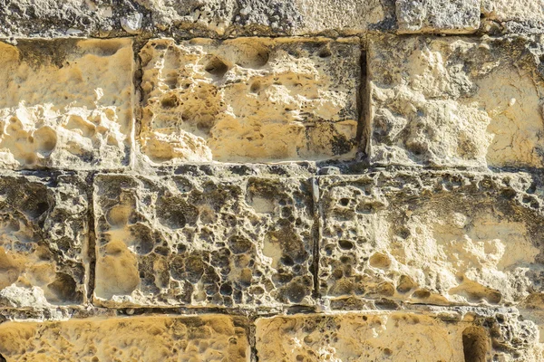 Eroded stone wall as background — Stock Photo, Image