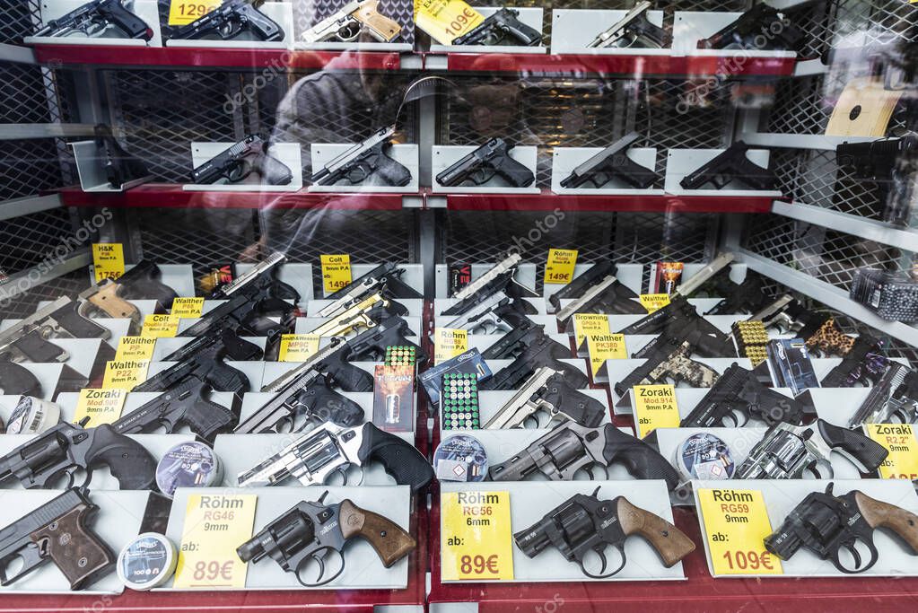 Hamburg, Germany - August 16, 2019: Display of a gun shop with blank pistols and revolvers in St. Pauli, Hamburg, Germany