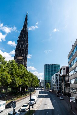 Hamburg, Almanya - 21 Ağustos 2019: Herrengraben caddesinin genel görünümü, trafiği olan şehir yolu ve Almanya 'nın Hamburg kentindeki St. Nikolai çan kulesi