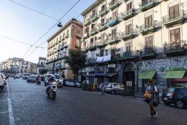 Naples, Italy - September 6, 2019: Street of old buildings with traffic and people around in the old town of Naples, Italy
