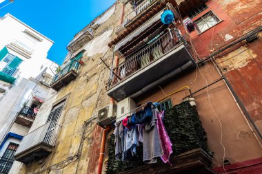 Napoli, İtalya 'nın tarihi merkezinde asılı giysileri olan eski klasik binalar.