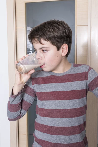 年轻的男孩喝一杯牛奶 — 图库照片