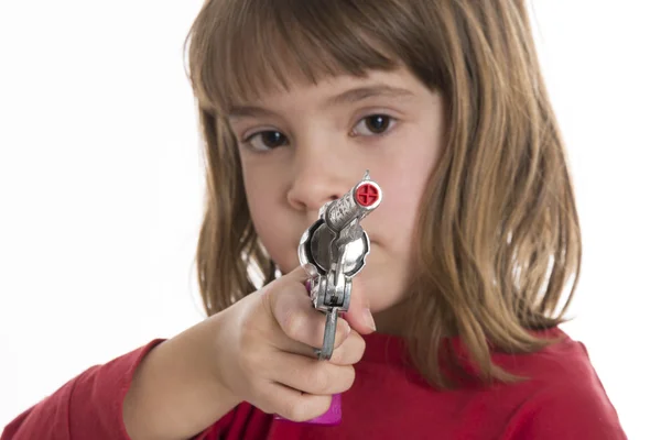 Bambina con una pistola giocattolo — Foto Stock