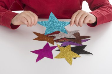Little girl playing with stars clipart