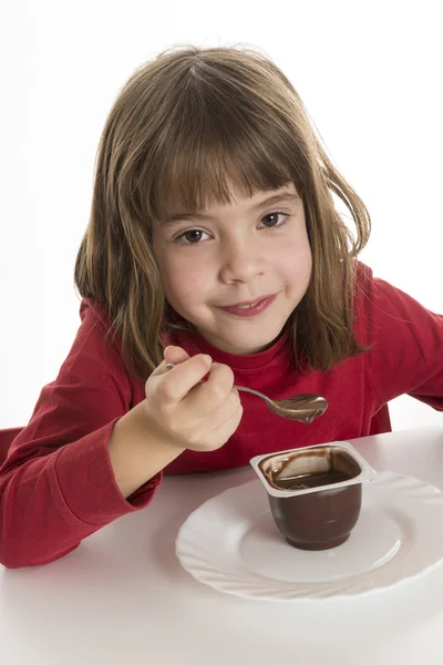 Little girl eating a custard — Stock Photo, Image