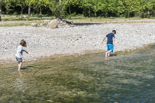 Children crossing a river — Stock Photo, Image