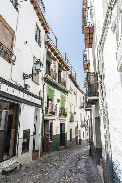 Granada, Spain - August 12, 2015: Street historical district of Albaicin, facing the hill of the Alhambra in Granada, Andalusia, Spain