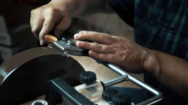 Man sharpens knives on a grinder. Close up hand — Stock Photo, Image