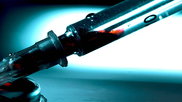 Drug addict prepares another dose of drugs with syringe