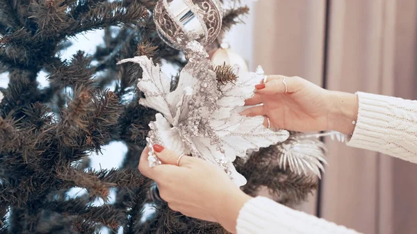 Les mains féminines décorent l'arbre de Noël avec des jouets à la maison — Photo