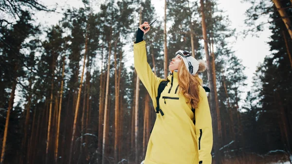 Menina tentando pegar um vínculo na floresta no inverno — Fotografia de Stock