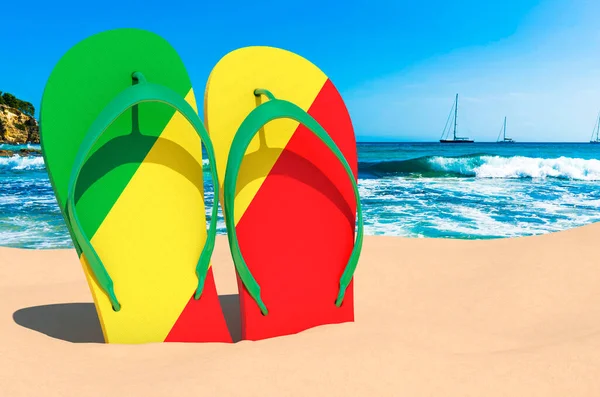 Flip flops with Congolese flag on the beach. Congo resorts, vacation, tours, travel packages concept. 3D rendering