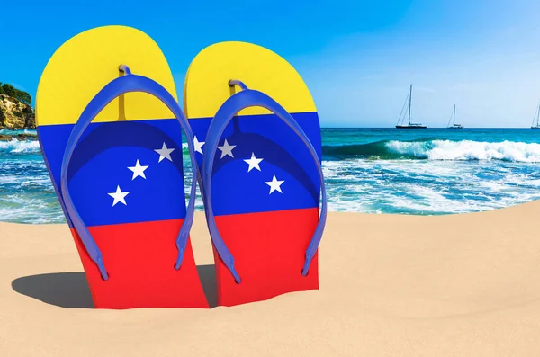 Flip flops with Venezuelan flag on the beach. Venezuela resorts, vacation, tours, travel packages concept. 3D rendering