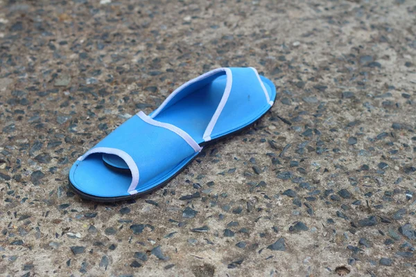 Slippers blue on a background of cement. — Stock Photo, Image