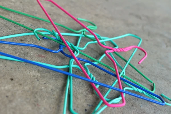 Colorful hangers shirt on a gray background.