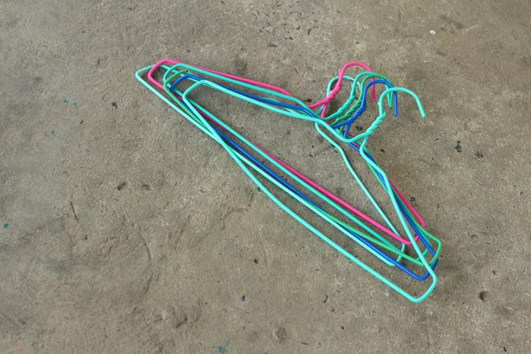 Colorful hangers shirt on a gray background.