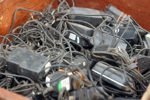 Battery charger used pile on the floor. — Stock Photo, Image