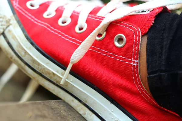 Scarpe rosse su sfondo marrone al parco . — Foto Stock