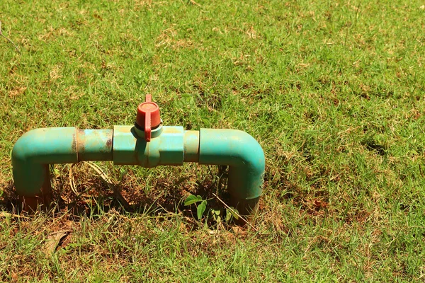 Water pipes on the green grass — Stock Photo, Image