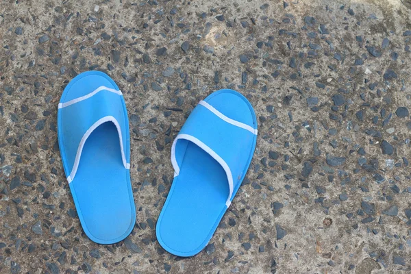 Slippers blue on a background of cement. — Stock Photo, Image